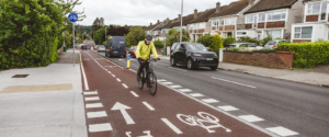 cyclist on a 2-way cycle lane - with passing car traffic - Walking and Cycling Index
