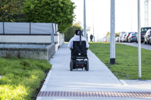 electric wheelchair user on footpath