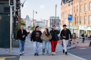 five walkers crossing a street junction in Cork city - Walking and Cycling Index