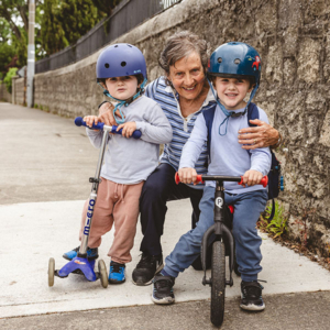 parent with two children on scooter and bike Dublin