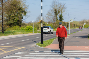 pedestrian male crossing road at zebra crossing junction Cork