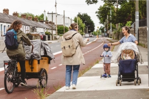 walker on foopath cyclist with carriage on cyclelane and woman with bbuggy and child on scooter 900x600