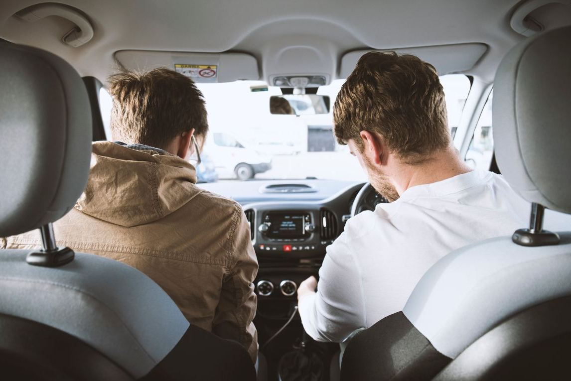 Image of two people in a car